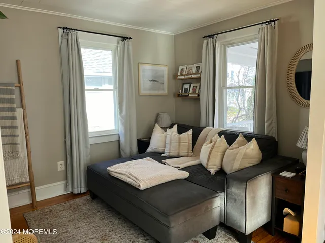 a living room with furniture window and wooden floor