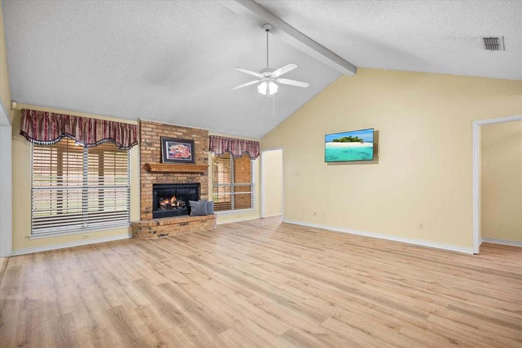 2824 Crestview Avenue Tyler, TX 75701 - Photo 7 of 39 an empty room with windows fireplace and wooden floor