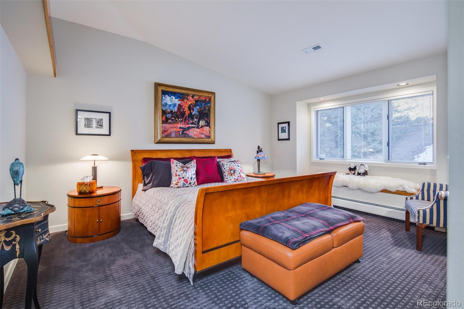 5852 Willowbrook Drive Morrison, CO 80465 - Photo 23 of 30 a bedroom with a bed and a couch