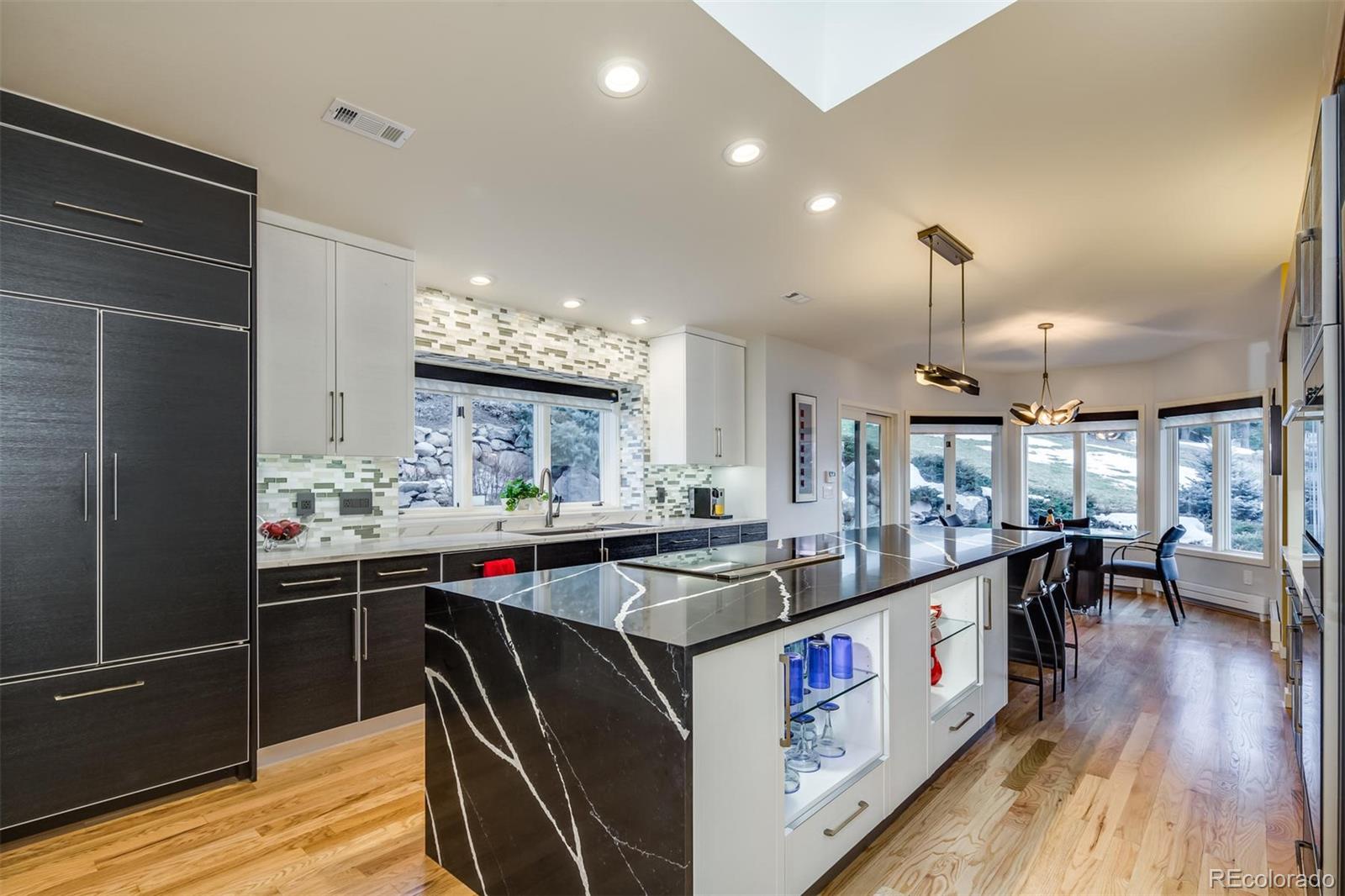 5852 Willowbrook Drive Morrison, CO 80465 - Photo 10 of 30 a kitchen with stainless steel appliances granite countertop a stove and cabinets