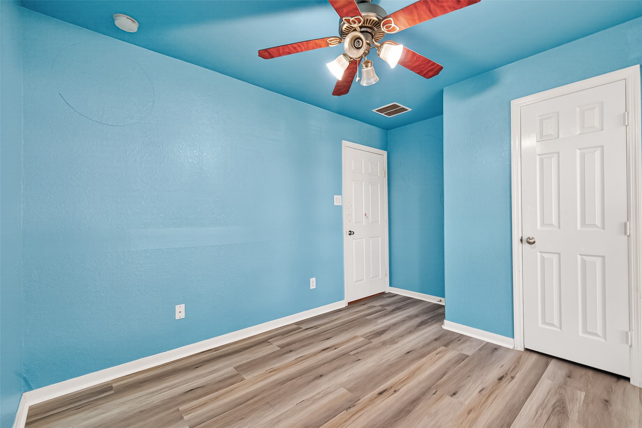 16715 Mackenzie Mesa Drive Spring, TX 77379 - Photo 27 of 50 wooden floor in an empty room with a chandelier fan