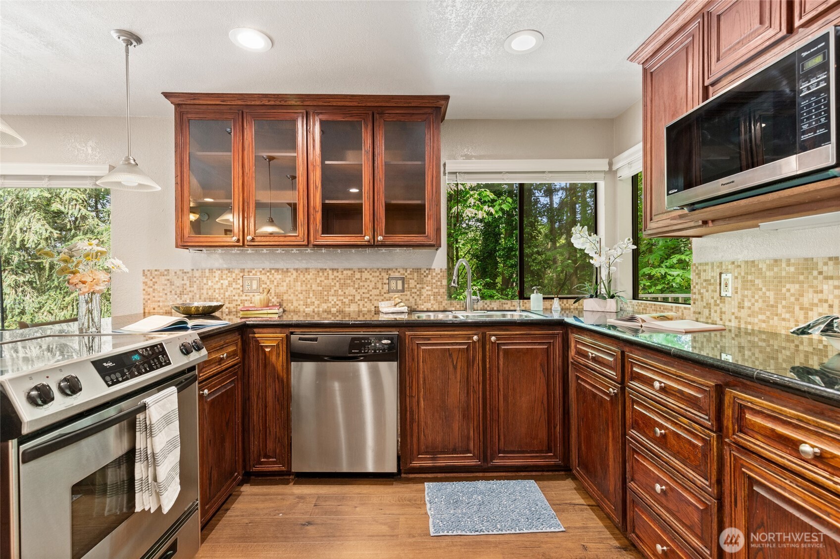 20817 29th Avenue Southeast Bothell, WA 98021 - Photo 11 of 40 a kitchen with stainless steel appliances granite countertop a stove sink and microwave