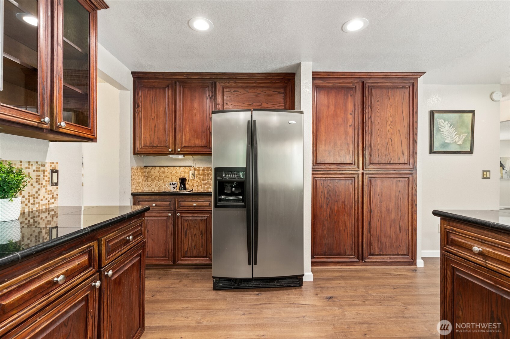 20817 29th Avenue Southeast Bothell, WA 98021 - Photo 12 of 40 a kitchen with granite countertop stainless steel appliances a refrigerator and cabinets