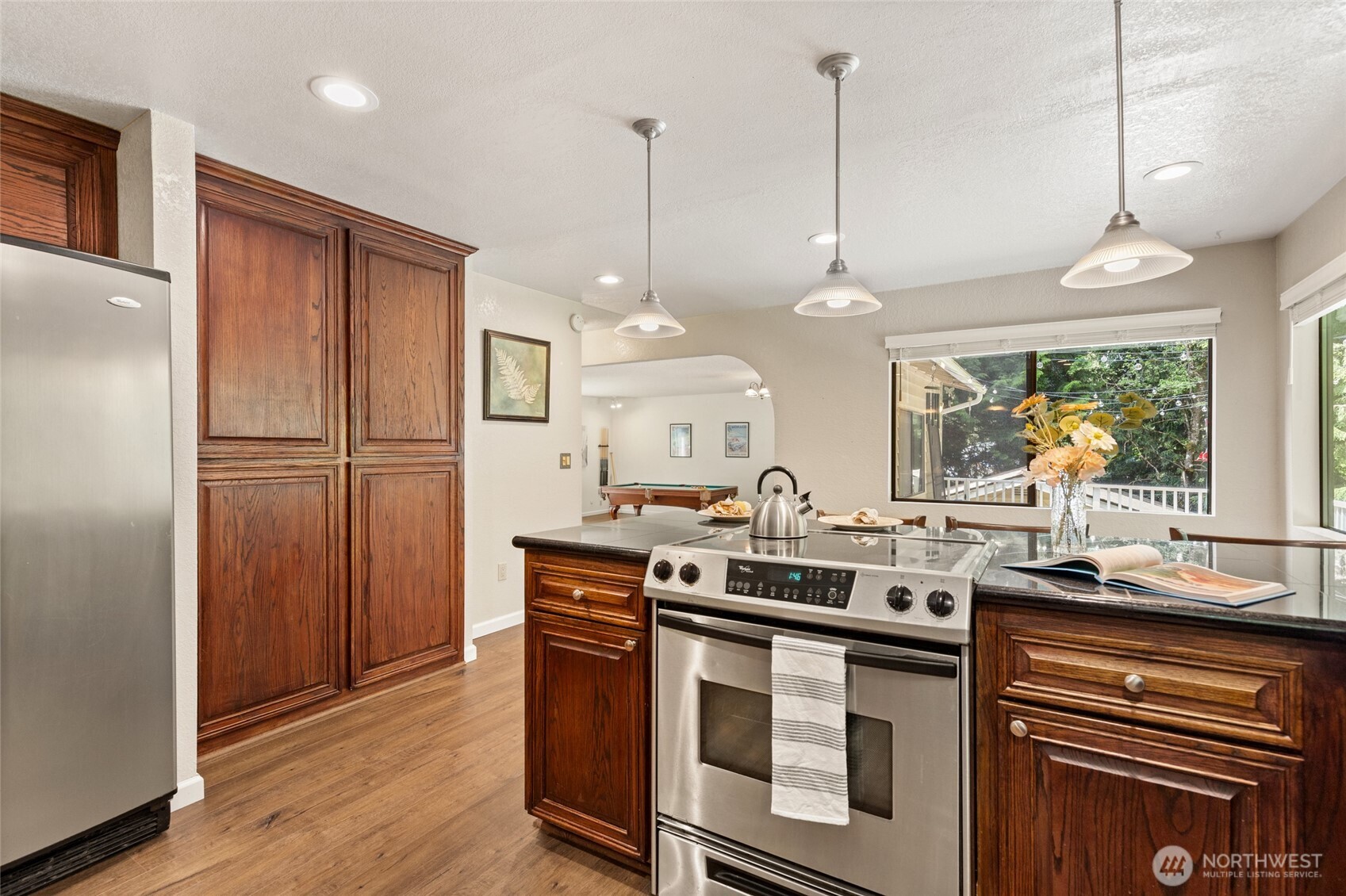 20817 29th Avenue Southeast Bothell, WA 98021 - Photo 13 of 40 a kitchen with stainless steel appliances granite countertop a stove a refrigerator and a sink