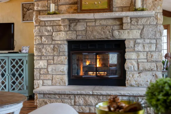 a dining room with furniture and a fireplace