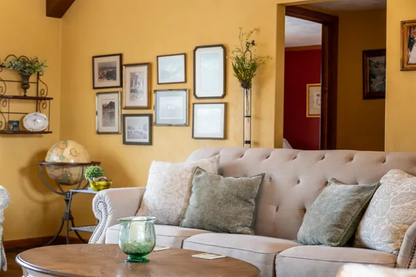 a living room with furniture a flat screen tv and a fireplace