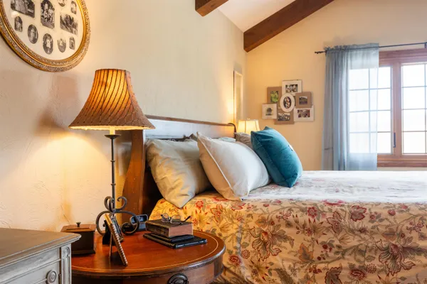 a view of a patio with table and chairs potted plants with floor to ceiling window and garden