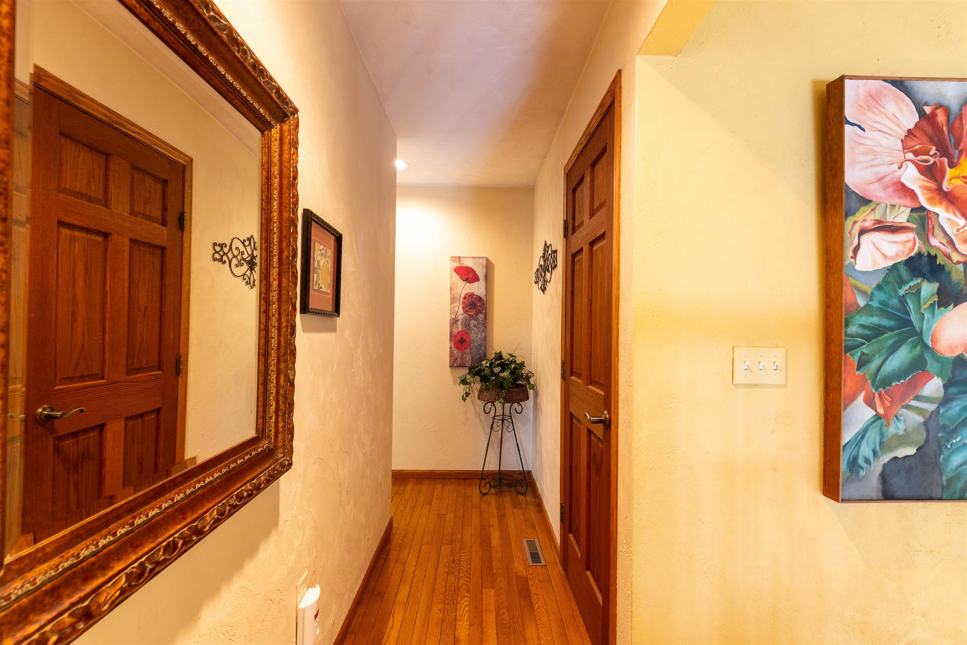 24 Butternut Lane Galena, IL 61036 - Photo 37 of 61 a view of a hallway with wooden floor and a potted plant