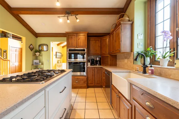 a bedroom with a bed a couch and dresser next to a window