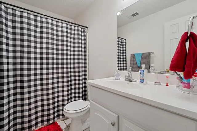 a bathroom with a sink toilet and a mirror