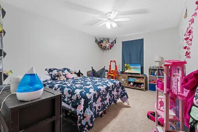 a bedroom with bed and a chandelier