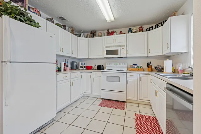 a kitchen with cabinets and appliances