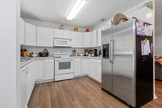 a kitchen with stainless steel appliances a refrigerator sink and cabinets
