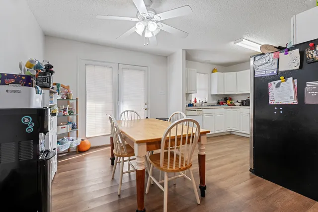 a dining room with furniture and wooden floor