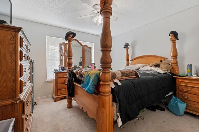 a bedroom with bed and a window