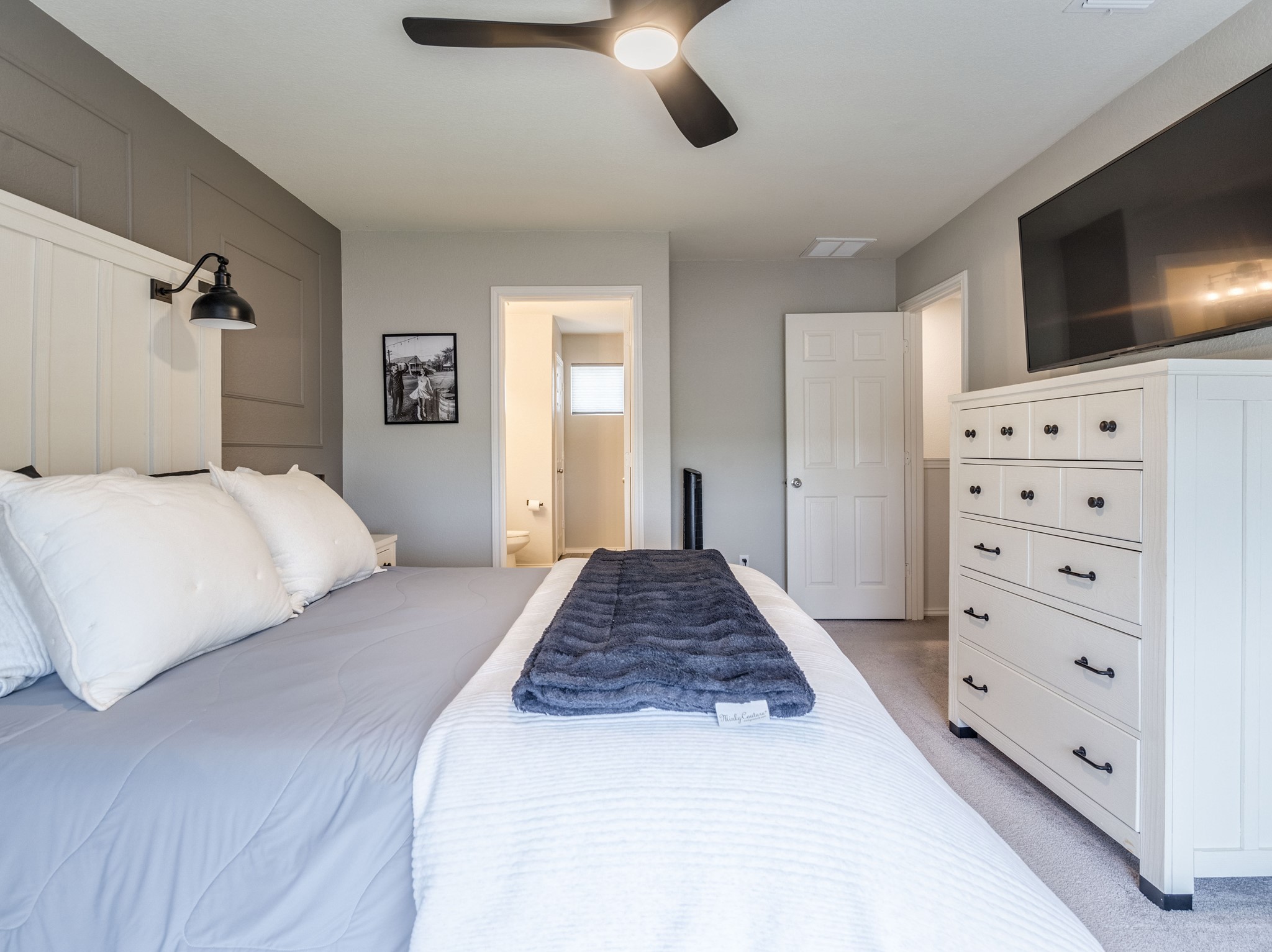 624 Pepperbark Loop Buda, TX 78610 - Photo 16 of 32 a bedroom with a bed closet and flat tv screen