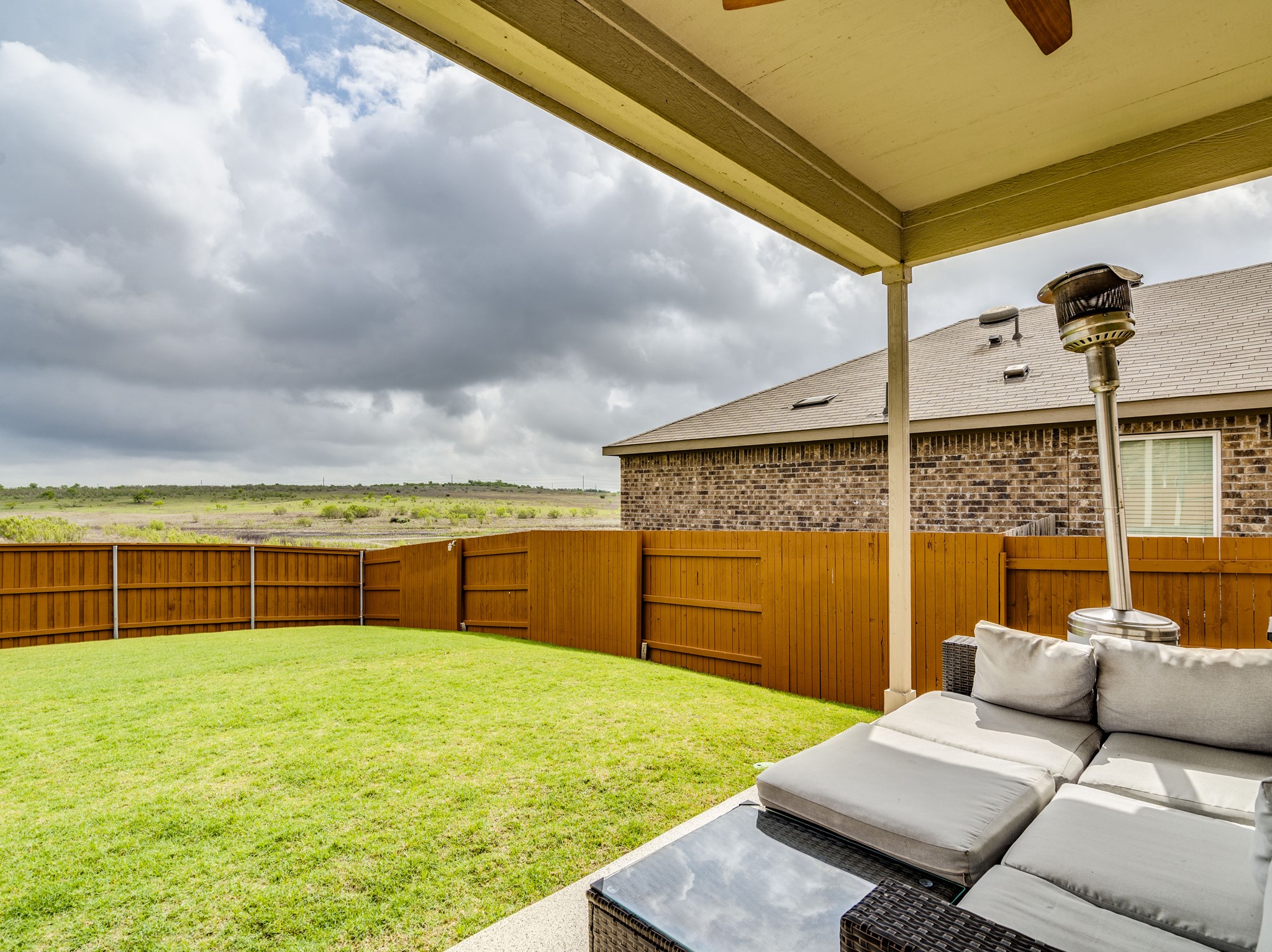 624 Pepperbark Loop Buda, TX 78610 - Photo 24 of 32 a view of a backyard with lawn chairs and iron fence