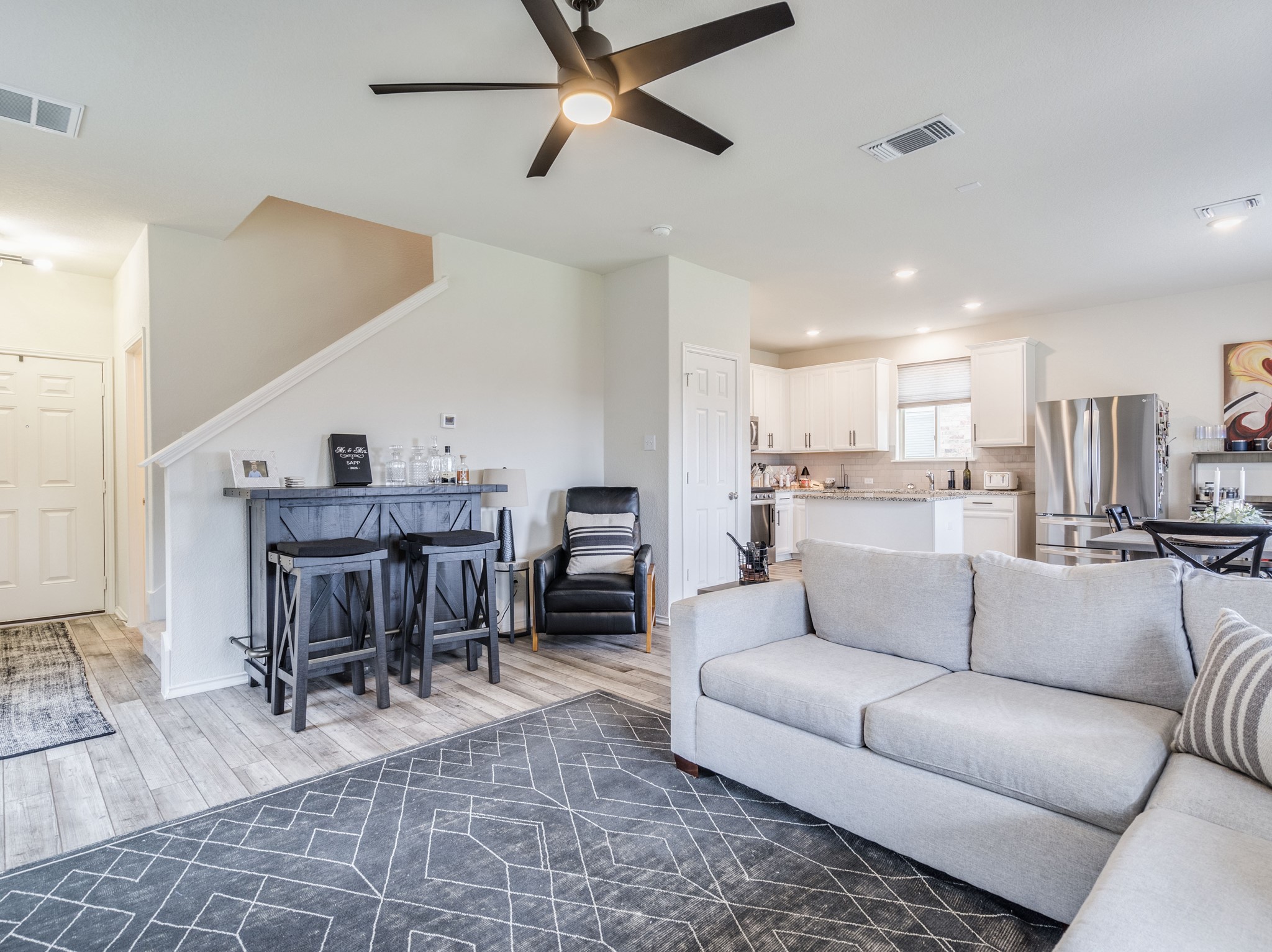 624 Pepperbark Loop Buda, TX 78610 - Photo 8 of 32 a living room with furniture a kitchen view and a dining table
