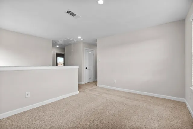 an empty room with a kitchen