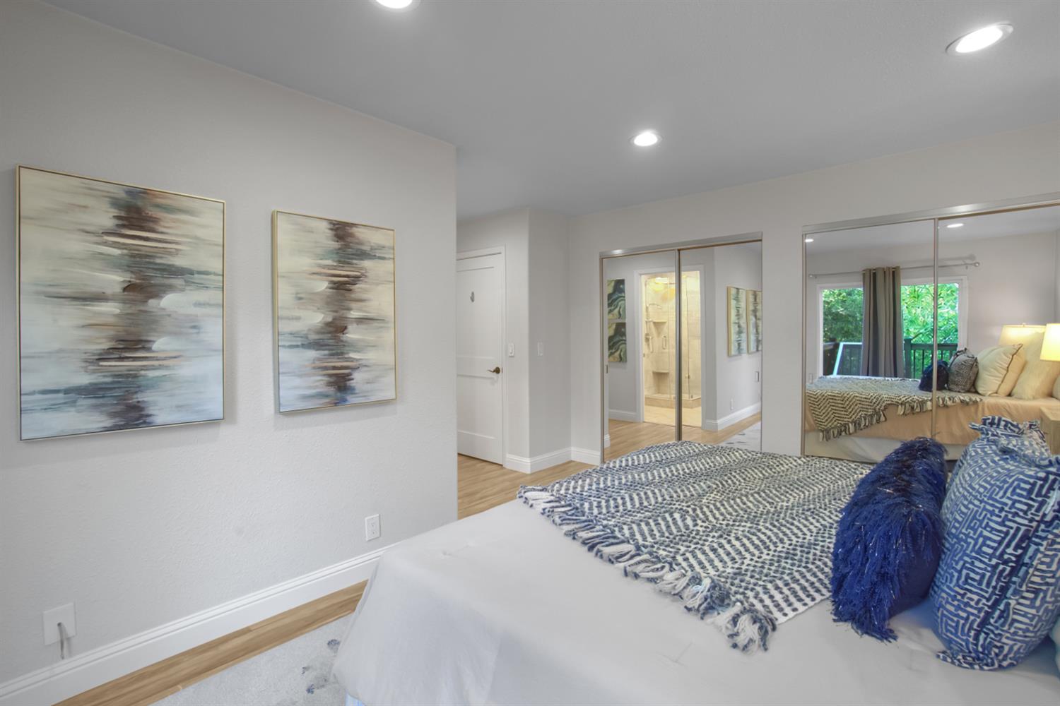 6299 Horseshoe Bar Road Loomis, CA 95650 - Photo 16 of 43 a spacious bedroom with a large bed and a chandelier