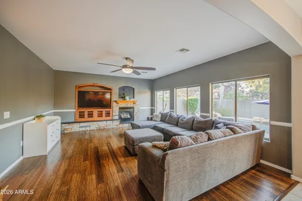 a view of a dining room with furniture a chandelier and wooden floor