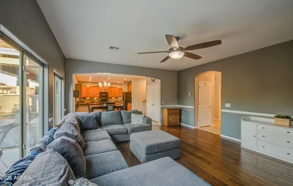 a kitchen with stainless steel appliances granite countertop a refrigerator a stove and a sink with wooden cabinets