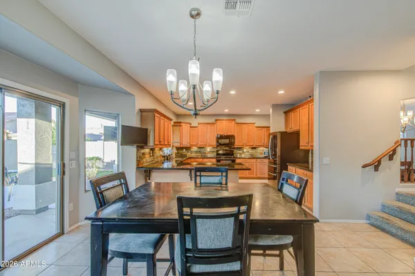 a kitchen with stainless steel appliances granite countertop a refrigerator sink and cabinets