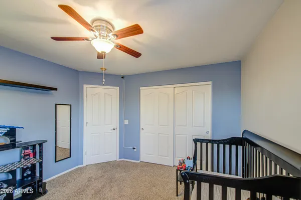 a view of a patio with couches table and chairs under an umbrella