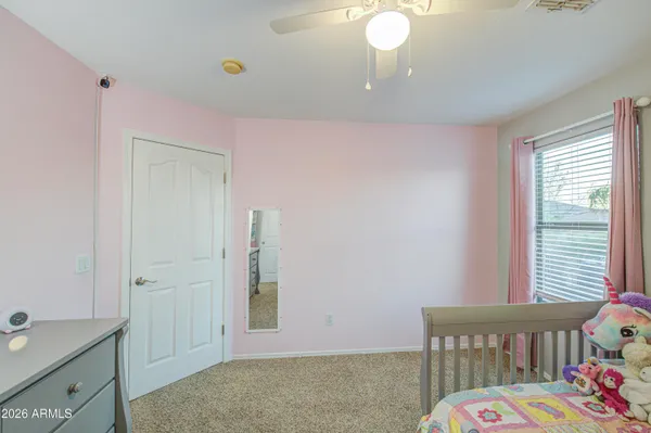 a blue swimming pool with a yard and palm trees