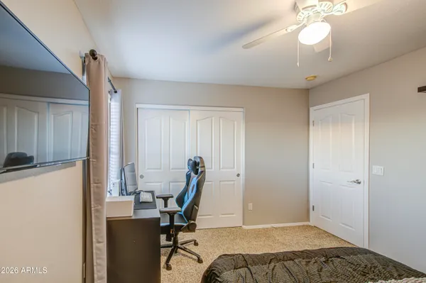 a view of a patio with table and chairs under an umbrella