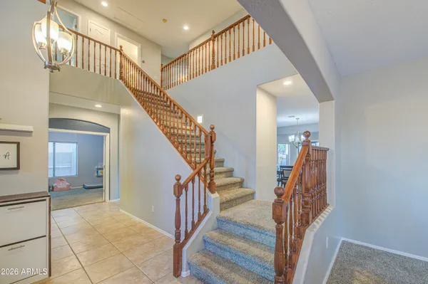 a view of a dining room with furniture and chandelier