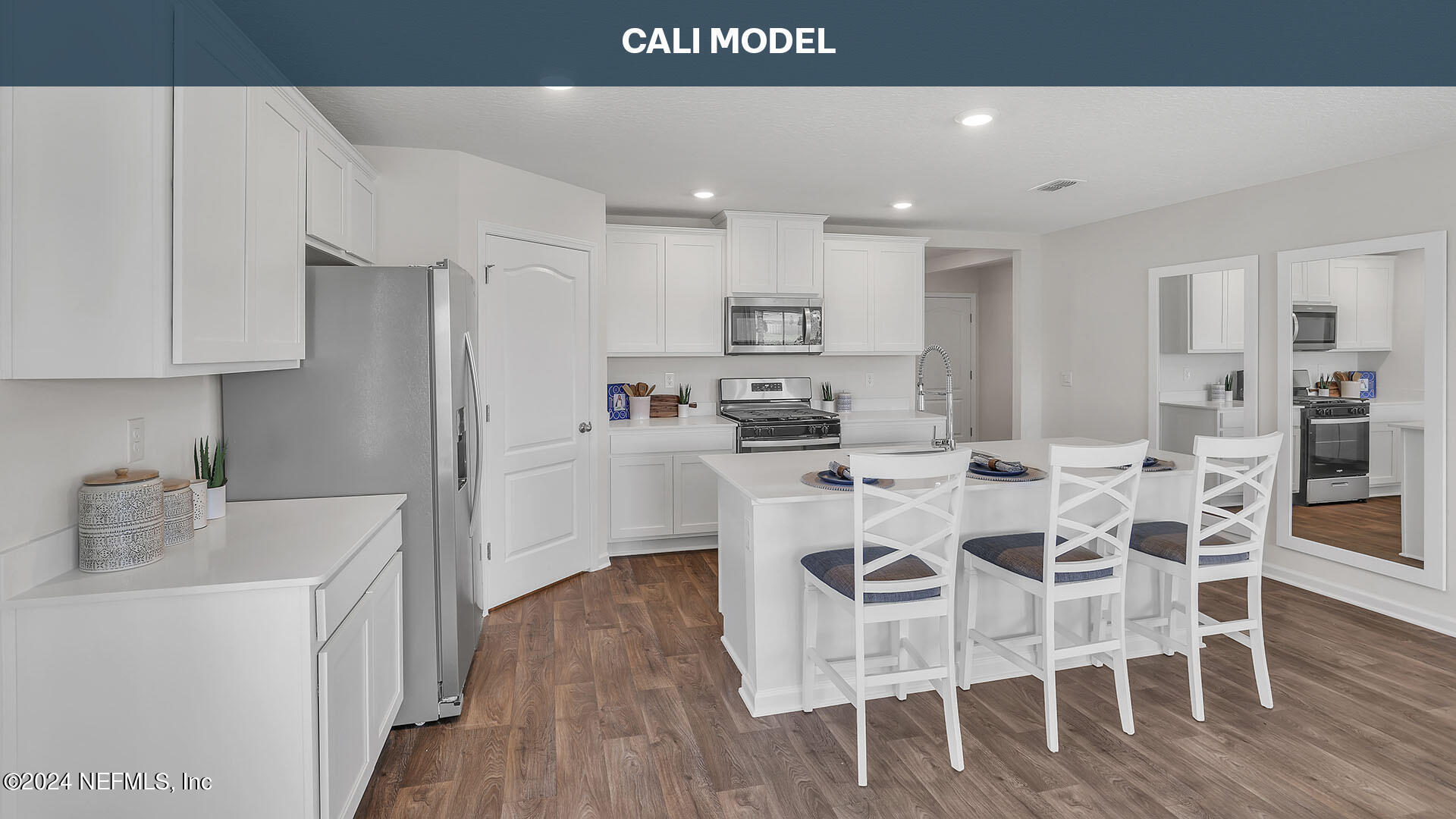 561 Orellana Road St. Augustine, FL 32084 - Photo 7 of 65 a kitchen with stainless steel appliances kitchen island granite countertop a refrigerator a stove a sink and white cabinets with wooden floor