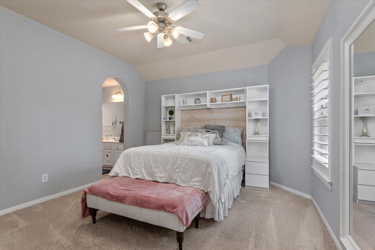 15519 Stallion Point Circle Cypress, TX 77429 - Photo 23 of 37 Bedroom featuring light-colored walls, carpeted flooring, and a ceiling fan with integrated lighting