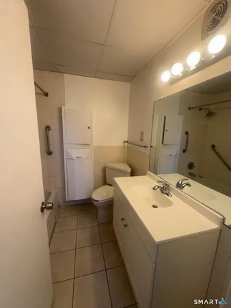 a bathroom with a sink a toilet and mirror