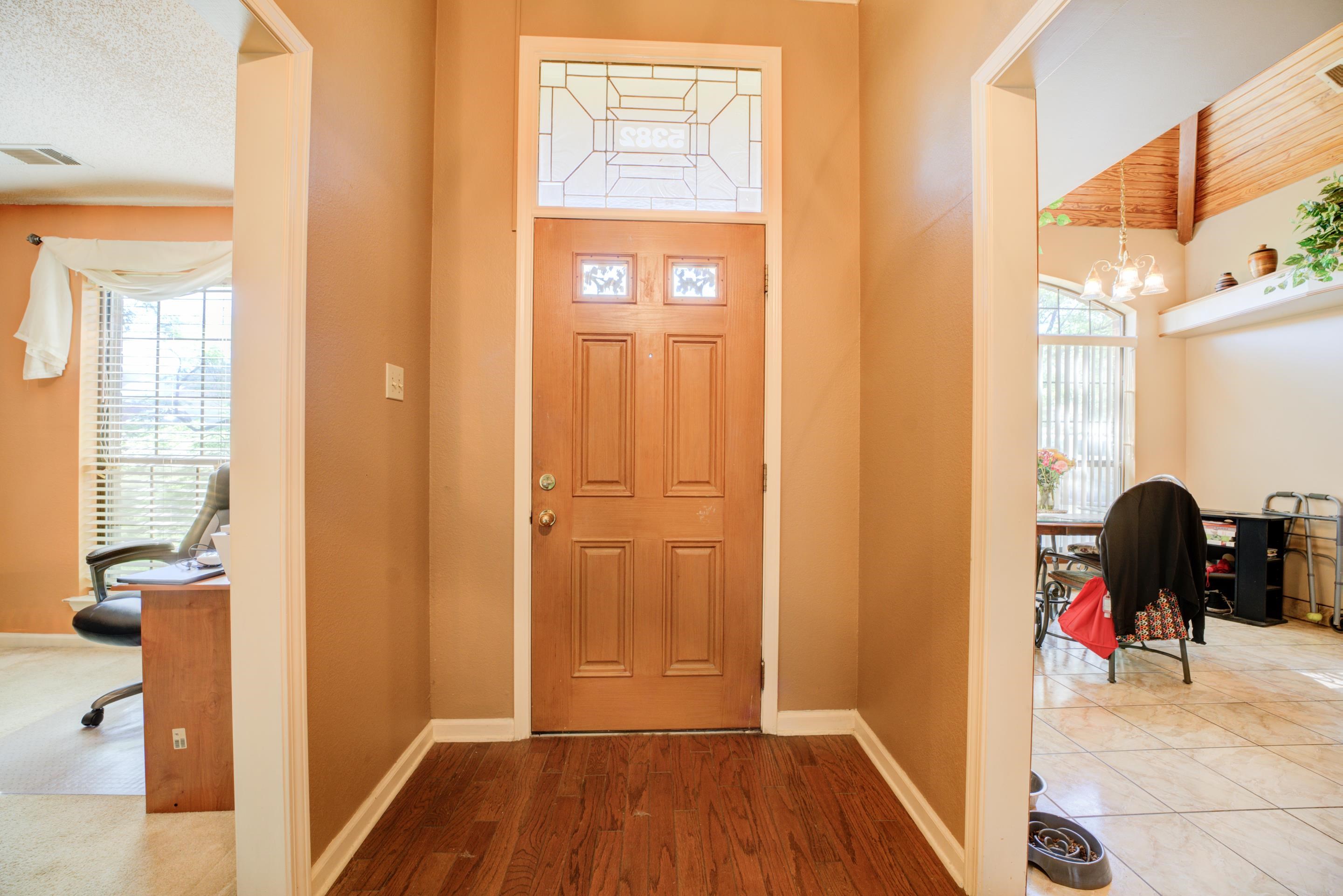 5382 Ross Road Memphis, TN 38141 - Photo 4 of 27 Foyer with a chandelier, wood finished floors, baseboards, and visible vents