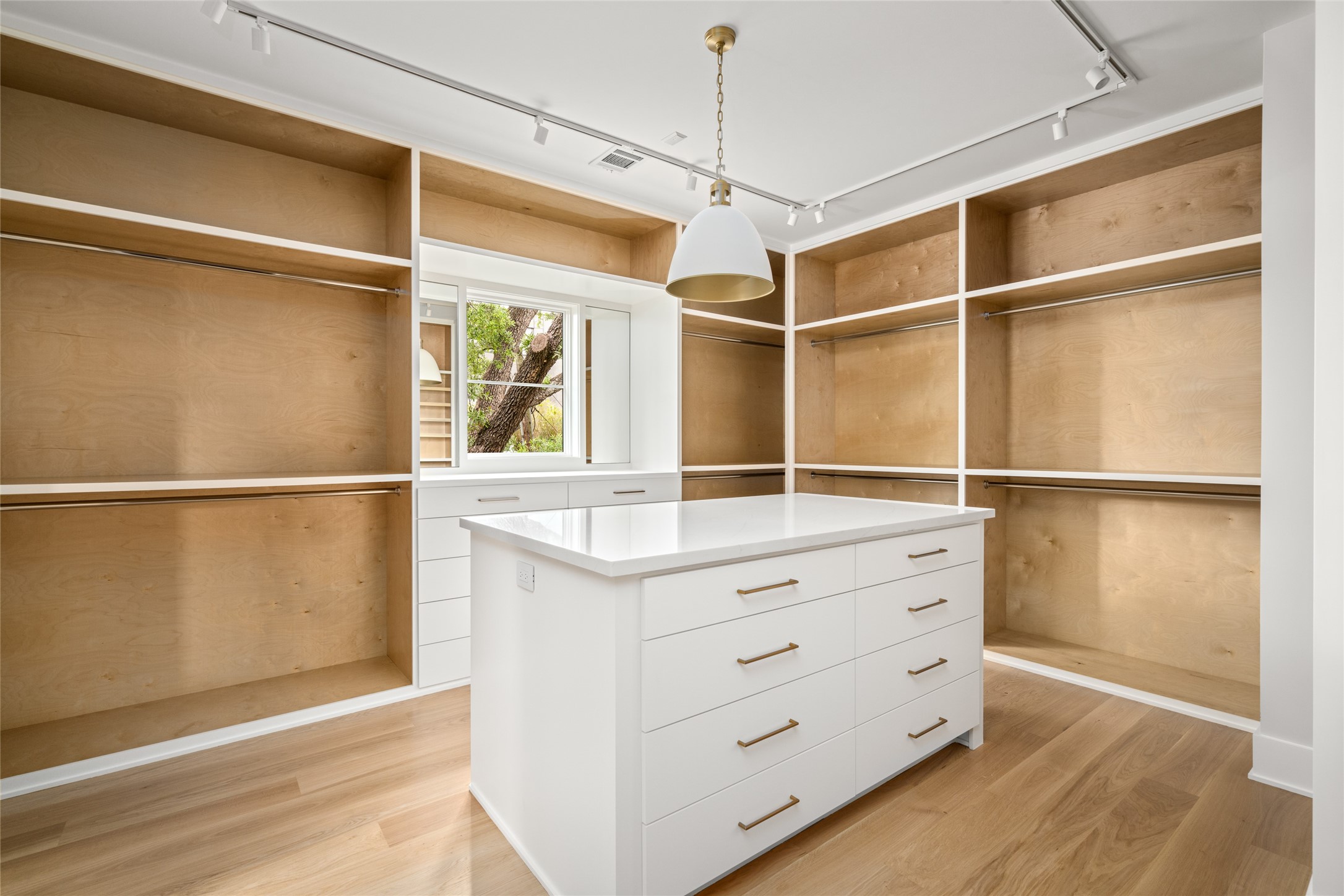 4006 Overbrook Lane Houston, TX 77027 - Photo 32 of 50 Designed for both style and utility, the primary closet offers a central island, generous storage, and a clean, tailored layout throughout.