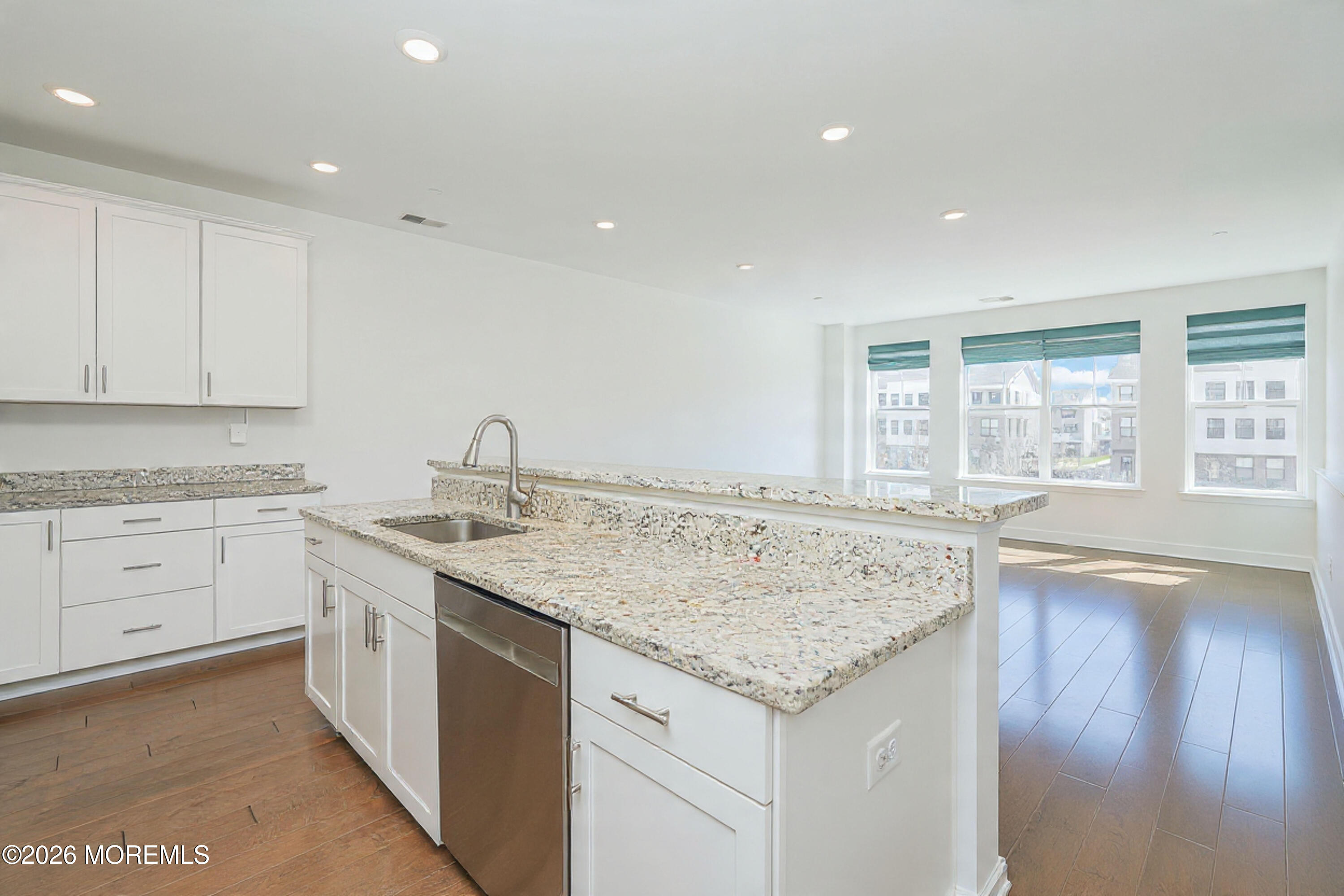37 Midway Road North Tinton Falls, NJ 07724 - Photo 14 of 46 a view of center kitchen island a sink a wooden floor and a window
