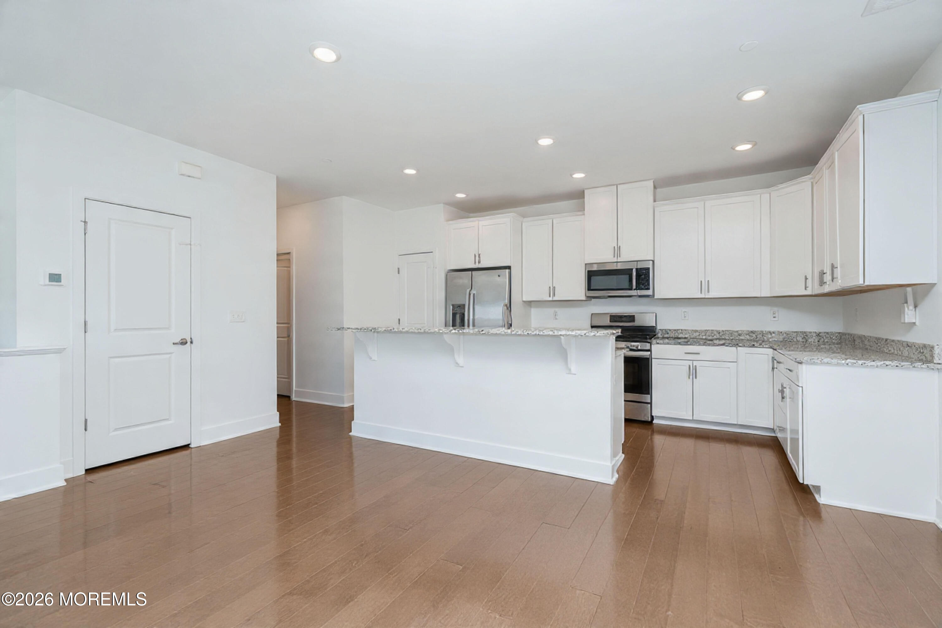 37 Midway Road North Tinton Falls, NJ 07724 - Photo 10 of 46 a kitchen with granite countertop white cabinets and stainless steel appliances