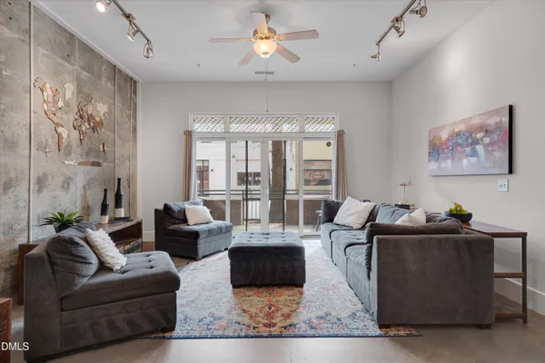 a living room with furniture and large windows