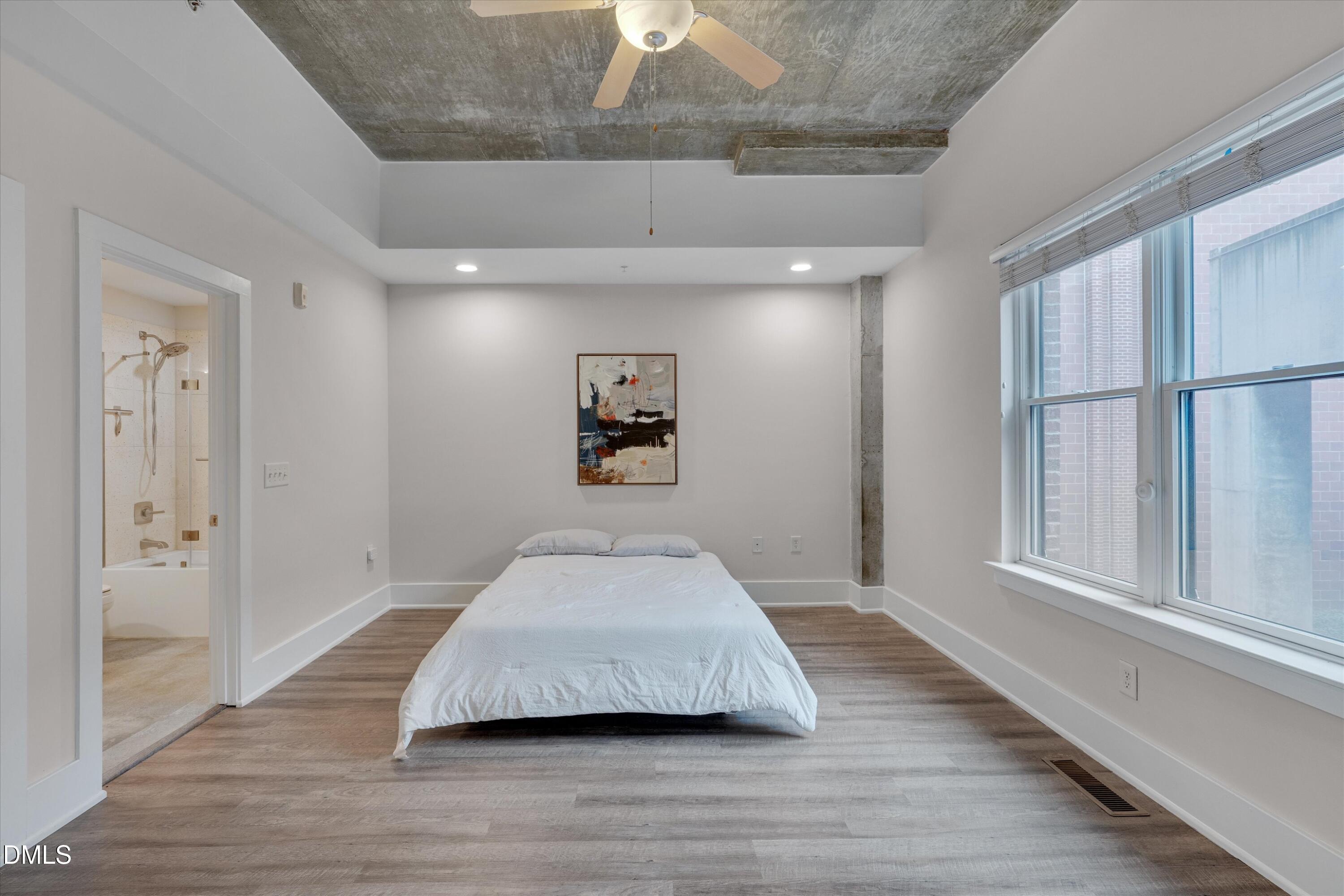 444 South Blount Street, Unit 120 Raleigh, NC 27601 - Photo 11 of 29 a room with wooden floor and windows