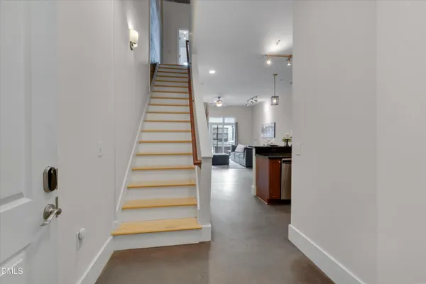 a view of entryway and hall with wooden floor