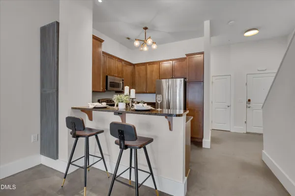 a kitchen with stainless steel appliances a refrigerator and a stove top oven