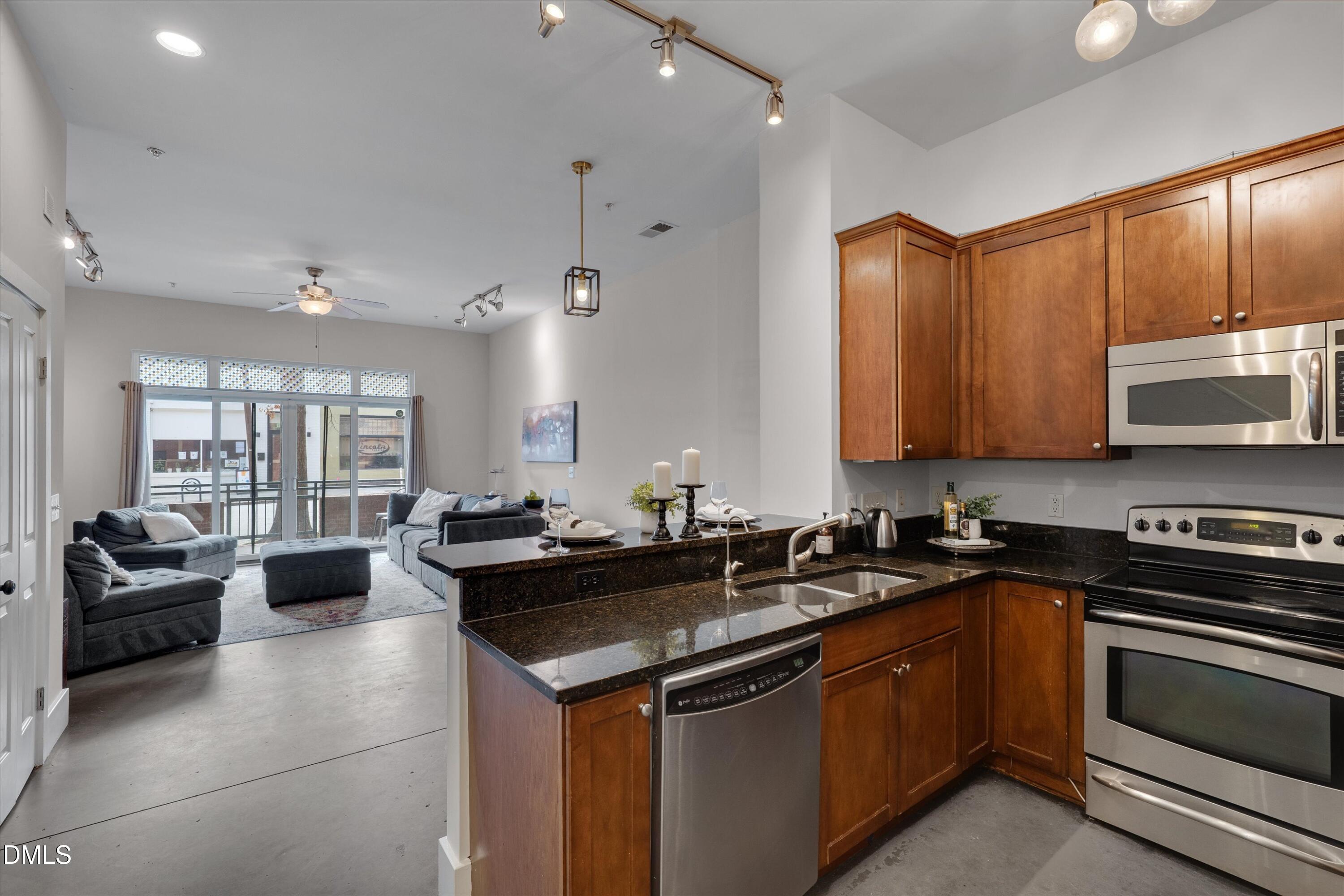 444 South Blount Street, Unit 120 Raleigh, NC 27601 - Photo 28 of 29 a kitchen with a sink stove and microwave