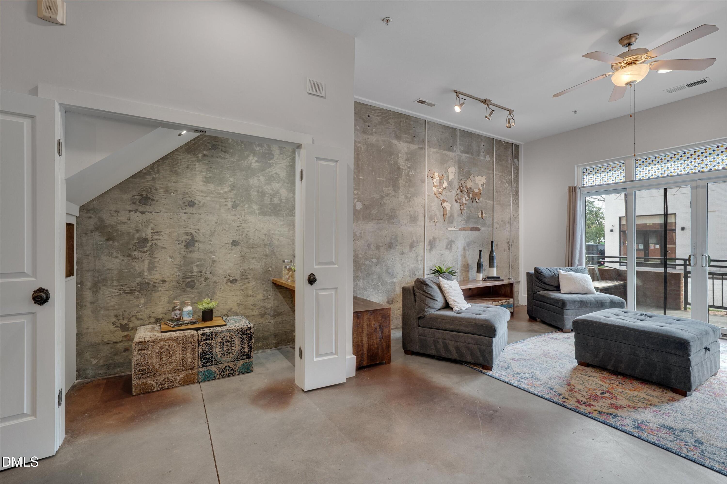 444 South Blount Street, Unit 120 Raleigh, NC 27601 - Photo 5 of 29 a living room with furniture and a large window