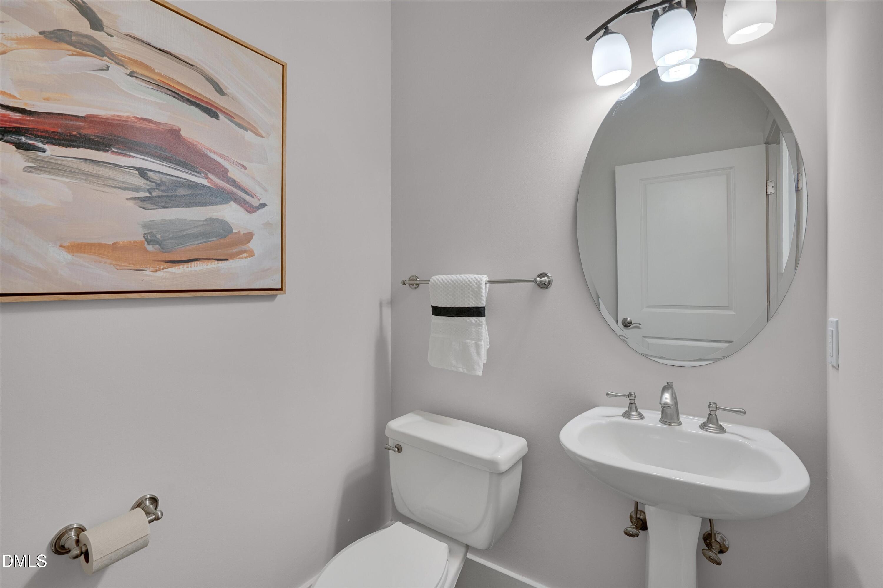 444 South Blount Street, Unit 120 Raleigh, NC 27601 - Photo 6 of 29 a bathroom with a toilet a sink and mirror