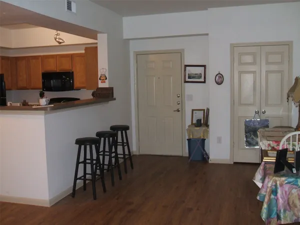 a view of a livingroom with furniture and a flat screen tv