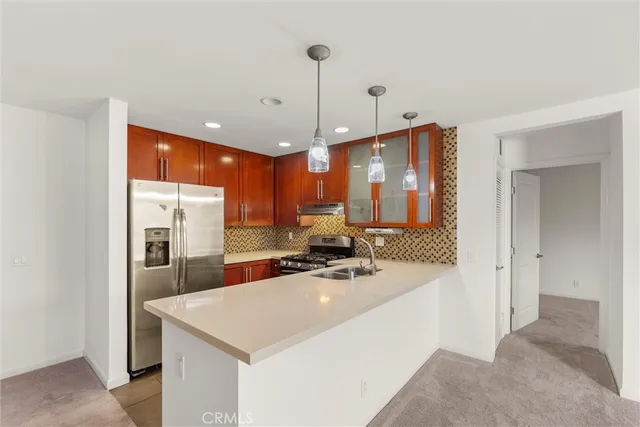 a kitchen with stainless steel appliances a sink stove and refrigerator
