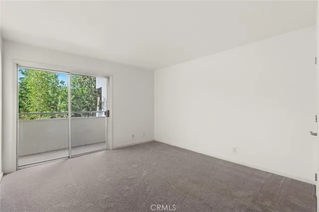 an empty room with large windows