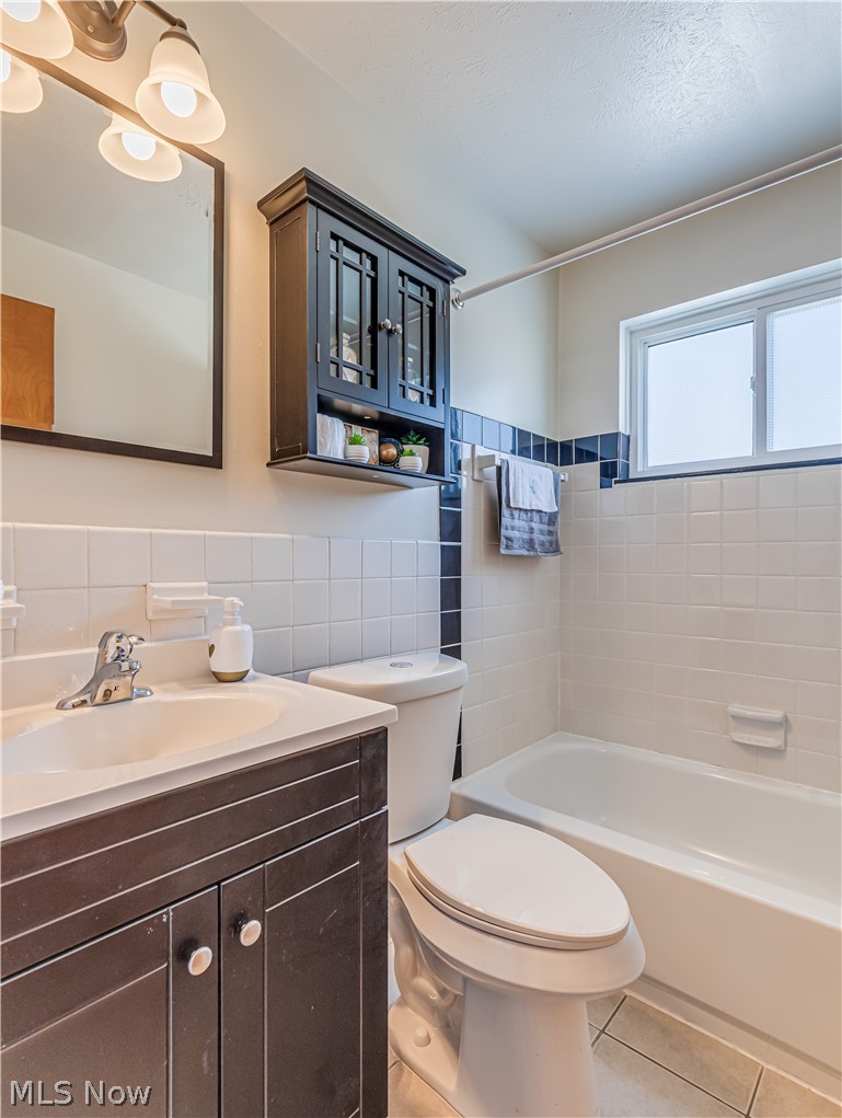 5382 Lee Road, Unit 204 Maple Heights, OH 44137 - Photo 14 of 15 Full bathroom featuring vanity, bathing tub / shower combination, and light tile patterned flooring