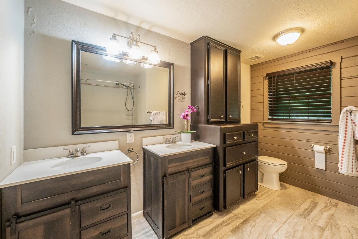 12049 Clark Lane Conroe, TX 77385 - Photo 18 of 40 a bathroom with a double vanity sink and a mirror